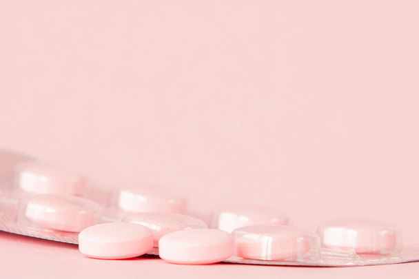 Pink pills on a pink background, copy space. - Photo, image