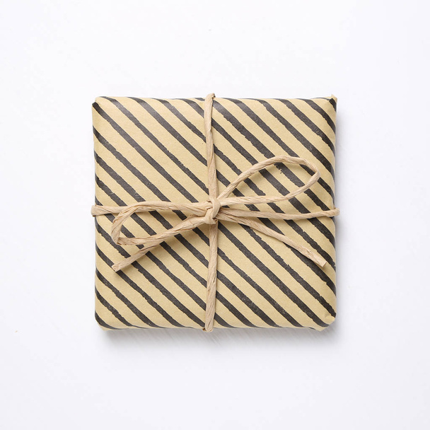 Brown striped pattern gift box isolated on white background - Photo, image