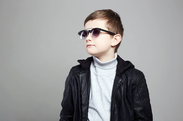 fashionable little boy in sunglasses. stylish kid in leather. fashion children - Photo, Image