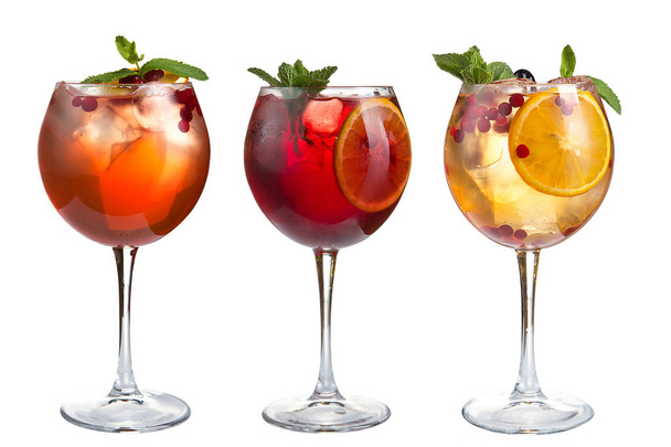 Alcoholic and non-alcoholic refreshing cocktails with mint, fruits and berries on a white background. Three cocktails in glass goblets. Isolated. - Фото, зображення