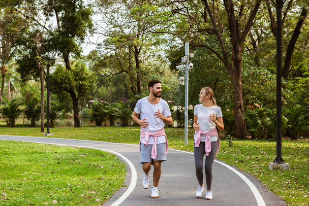 couple jogging and running in the park - 写真・画像