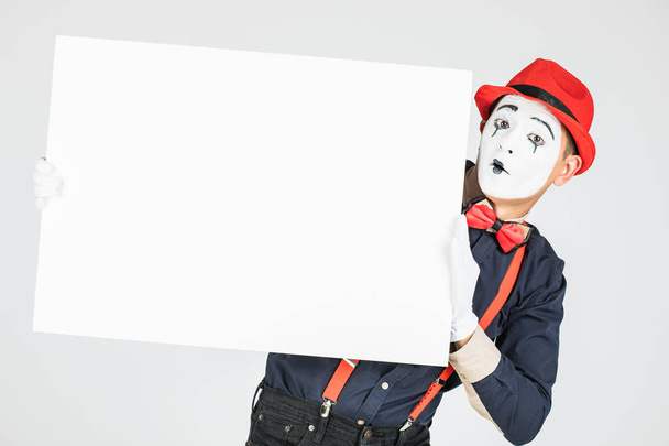 happy MIME artist holding a blank white Board, on a white background - Photo, Image