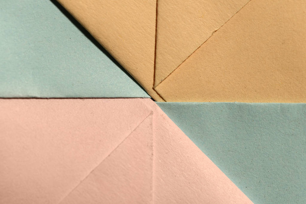 Abstract geometric paper shapes. Pastel tones crumpled paper. Hard light. - 写真・画像