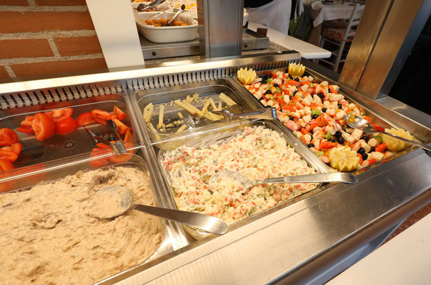 Inside a self service restaurant with many raw and cooked foods - Photo, Image
