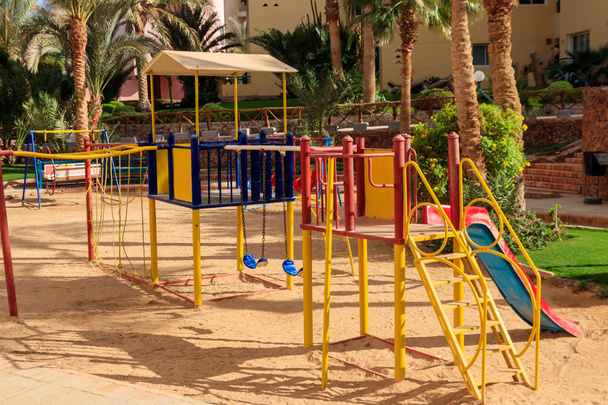 Colorful playground equipment for children in tropical holiday resort - Photo, Image