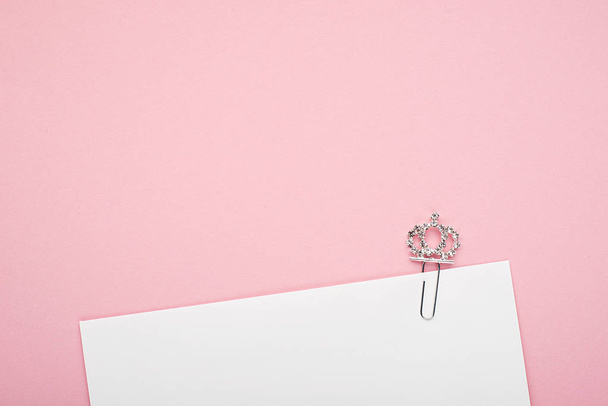 Background pink envelope shiny princess crown. The concept of an invitation to the holiday of the birth of a little girl princess. Horizontal. Copy space - 写真・画像