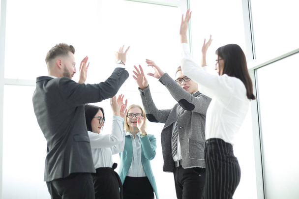 business team rejoices, standing in the office. - Фото, изображение