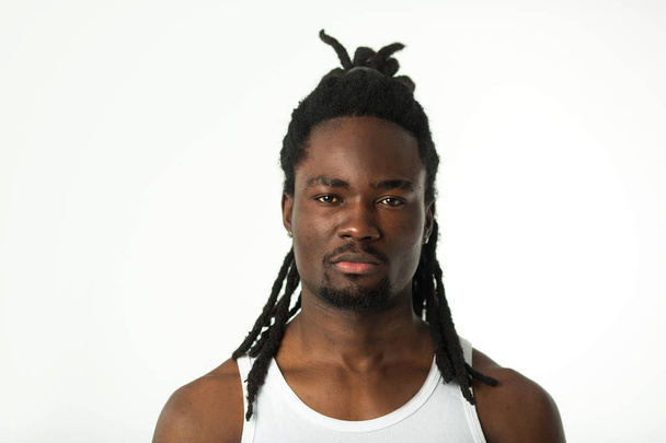 handsome stylish african man with dreadlocks hair on a white background - Foto, Imagen