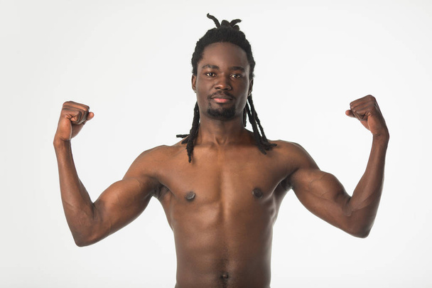 handsome stylish african man with dreadlocks hair on a white background - Fotó, kép