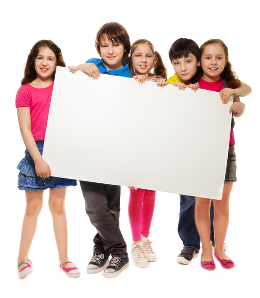 Group of schoolchildren holding white board - Foto, afbeelding