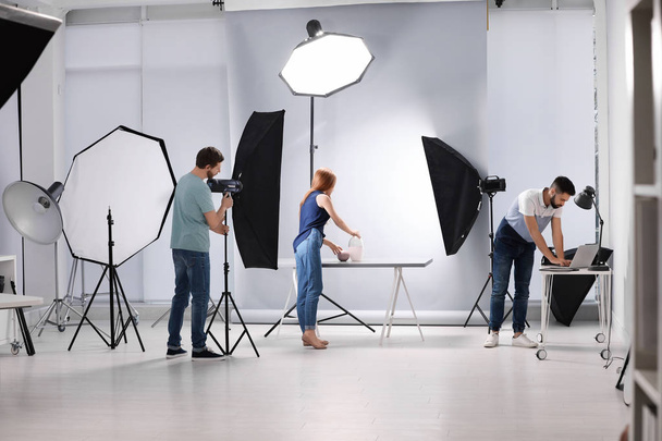Photo studio with professional equipment and team of workers - Φωτογραφία, εικόνα