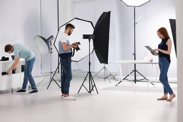 Photo studio with professional equipment and team of workers - Foto, afbeelding
