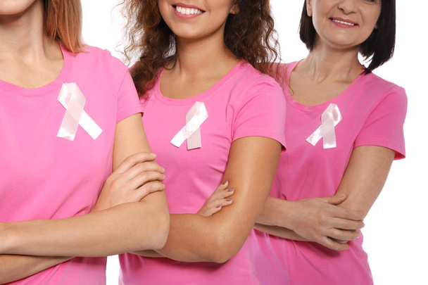 Group of women with silk ribbons on white background, closeup. Breast cancer awareness concept - Photo, Image