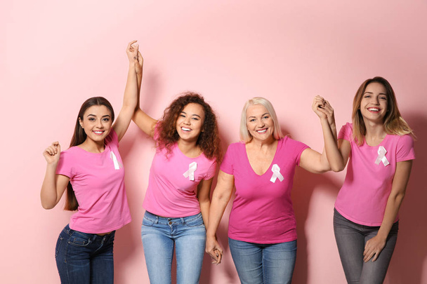 Group of women with silk ribbons on color background. Breast cancer awareness concept - Foto, Imagen
