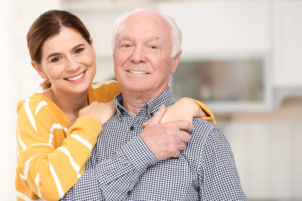 Elderly man with female caregiver in kitchen - Zdjęcie, obraz