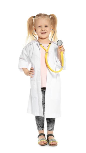 Cute little child in doctor coat with stethoscope on white background - Foto, imagen