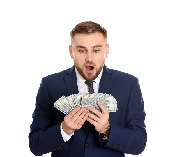 Portrait of young businessman holding money banknotes on white background - Foto, immagini