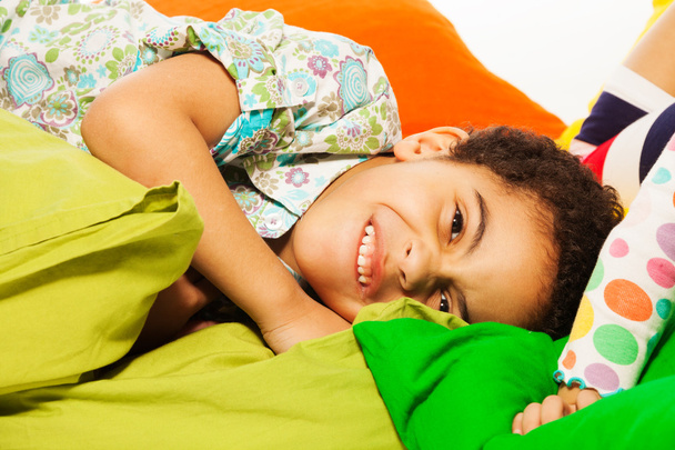 Happy black boy laying on the pillows - Photo, Image