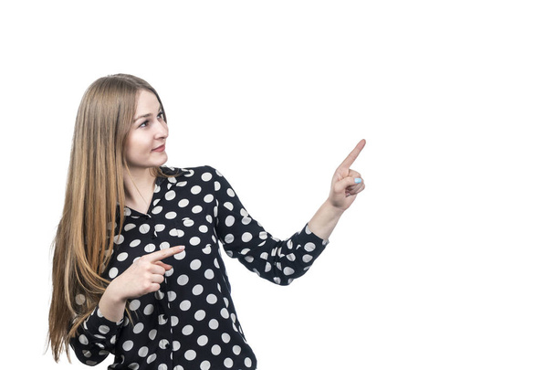 Business woman in a polka dot shirt points her finger in the side and up isolated on white background - Fotoğraf, Görsel