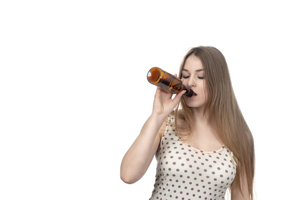 beautiful woman drinking from bottle with closed eyes isolated on white background - Foto, immagini