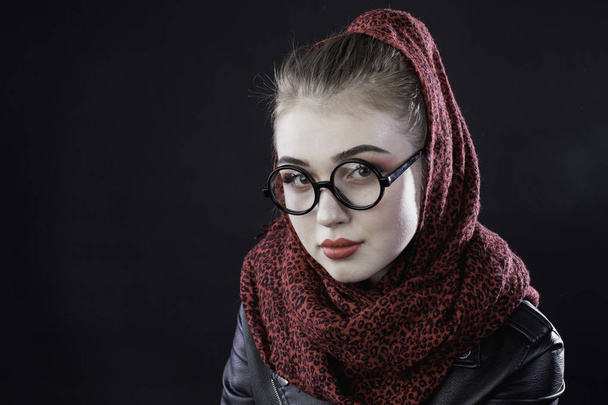portrait of a young girl with glasses on a dark background in th - Фото, изображение