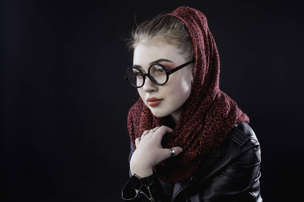 portrait of a young girl with glasses on a dark background in th - Фото, изображение