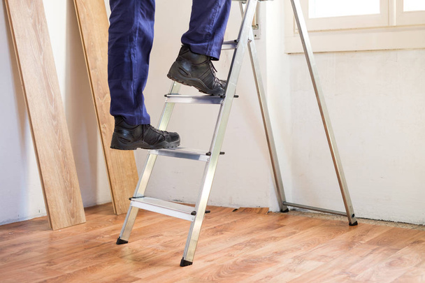 Home renovation and repairing concept with ladder on parquet floor - Fotoğraf, Görsel