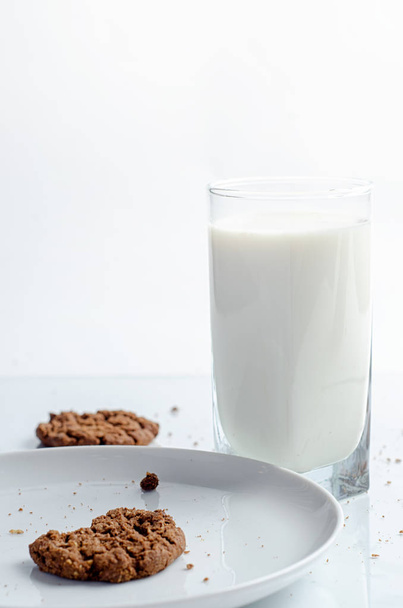 chocolate chip cookies and glass of milk on white background - Fotoğraf, Görsel