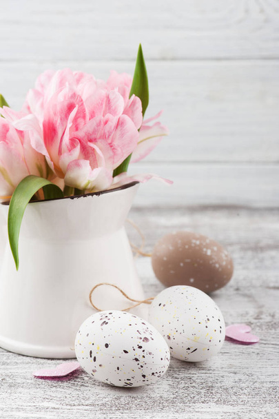 Fresh pink tulip flowers in jug, hearts and Ester eggs on rustik wooden background - Photo, Image