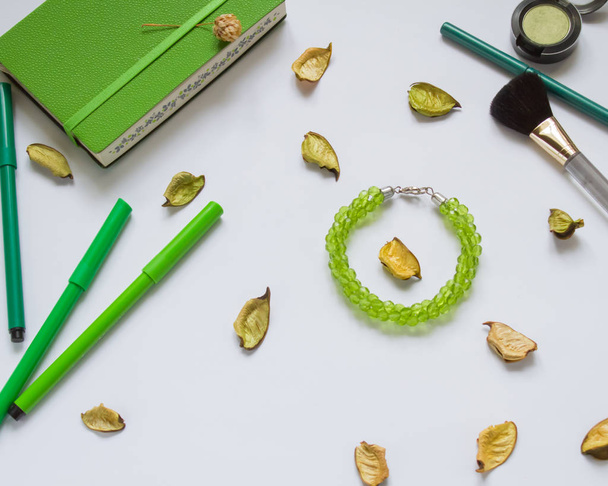 green Notepad and pencils on white background, cosmetics, brush, jewelry, female - Photo, Image