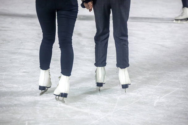 feet on the skates of a person rolling on the ice rink. - 写真・画像