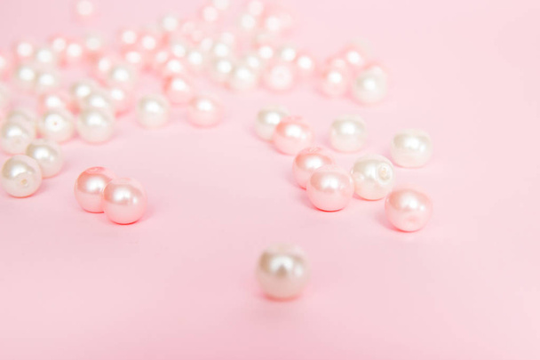 Roze parels op roze achtergrond close-up. - Foto, afbeelding