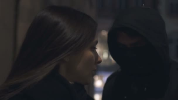 Thief in mask suffocating female victim, extorting money, street violence - Materiał filmowy, wideo