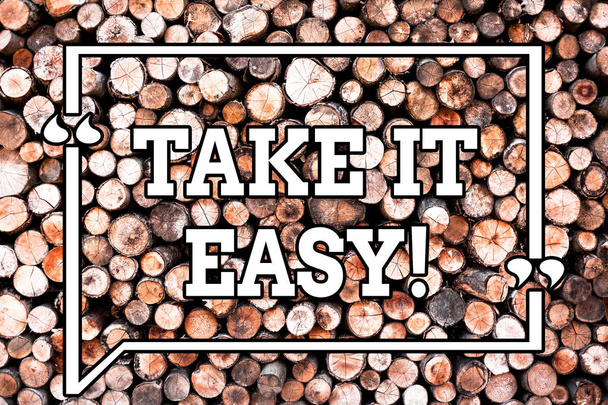 Text sign showing Take It Easy. Conceptual photo Be relaxed do not worry about things stay calmed and rest Wooden background vintage wood wild message ideas intentions thoughts. - Photo, Image