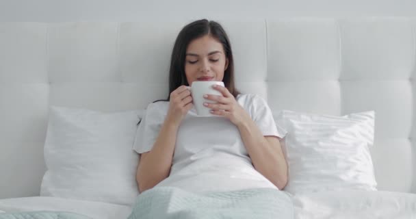 Good morning Girl having morning coffee in bed  - Кадры, видео
