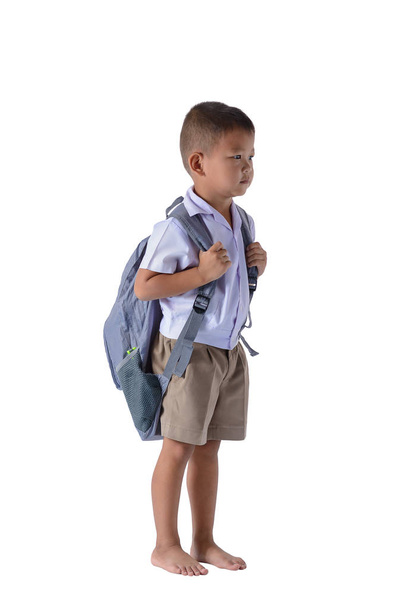 yan görünümü izole kırpma yolu ile beyaz arka plan üzerinde sırt çantası ile okul üniformalı Asya ülke çocuk portresi - Fotoğraf, Görsel