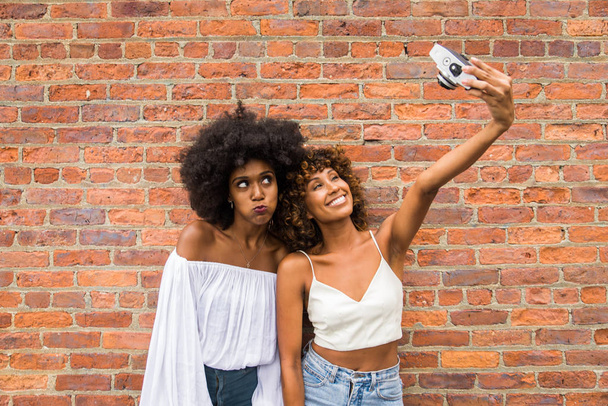 Group of afroamerican friends bonding in Manhattan, New York - Young adults having fun outdoors, concepts about lifestyle and young adult generation - 写真・画像