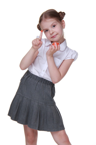 Lovely schoolgirl posing with orange paint - Фото, зображення