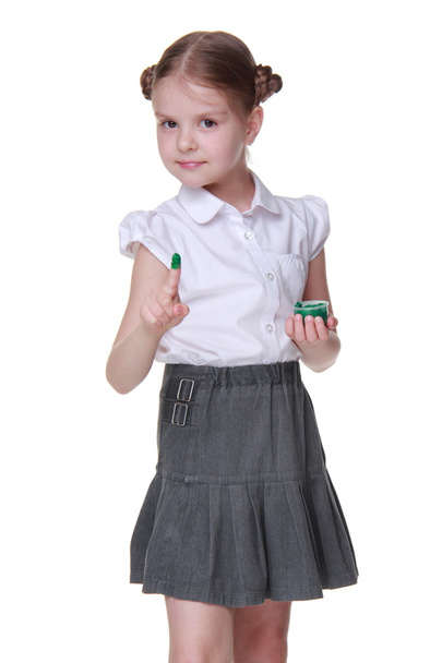 Lovely schoolgirl posing with green paint - 写真・画像