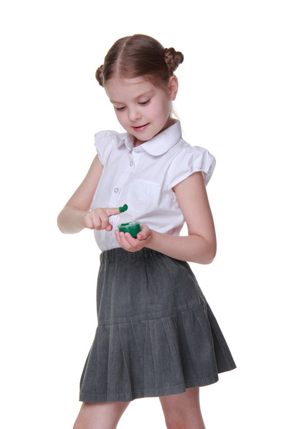 Lovely schoolgirl posing with green paint - Foto, afbeelding