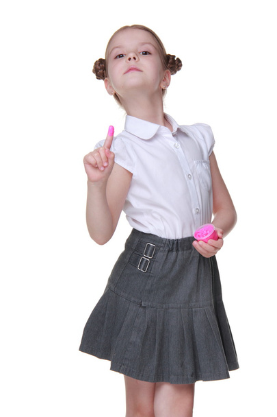 Lovely schoolgirl posing with pink paint - Foto, imagen