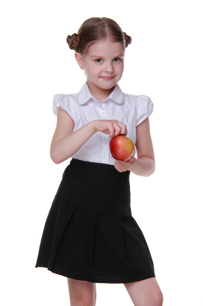 Portrait of a beautiful schoolgirl holding an apple - Photo, Image