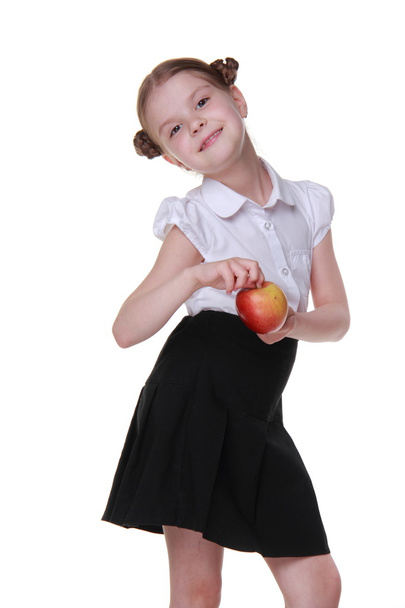 Portrait of a beautiful schoolgirl holding an apple - Foto, Imagen