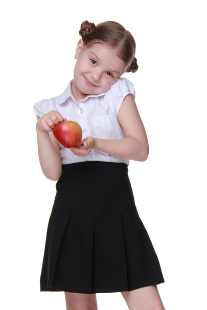 Portrait of a beautiful schoolgirl holding an apple - Zdjęcie, obraz