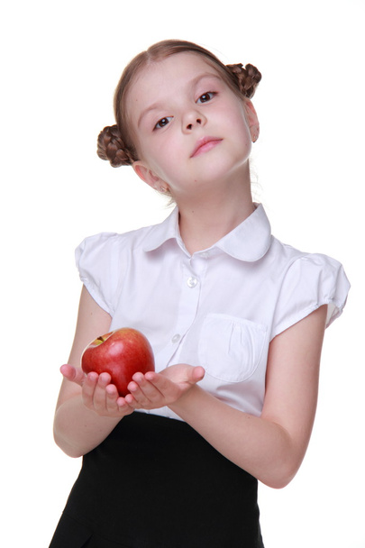 Portrait of a beautiful schoolgirl holding an apple - Fotó, kép