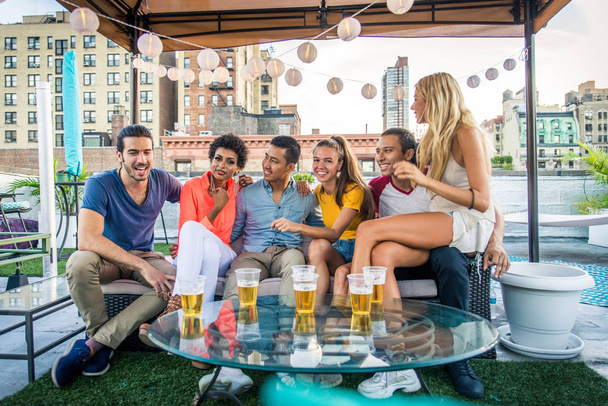 Young happy people having a barbecue dinner on a rooftop in New York - Group of friends having party and having fun - Fotoğraf, Görsel