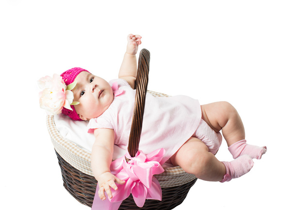 beautiful girl baby in a basket on a white background isolated - Valokuva, kuva