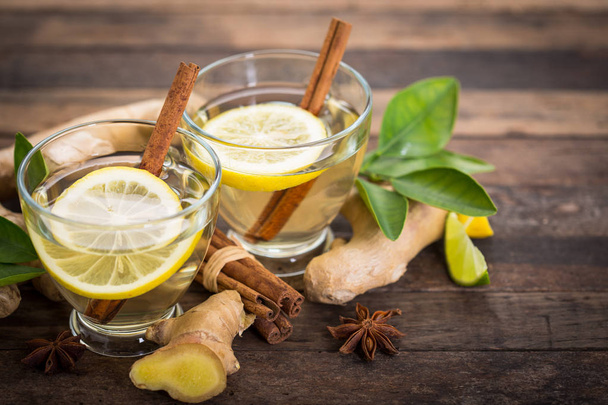 close up view of refreshing ginger hot tea with lemon on wooden tabletop - Foto, immagini
