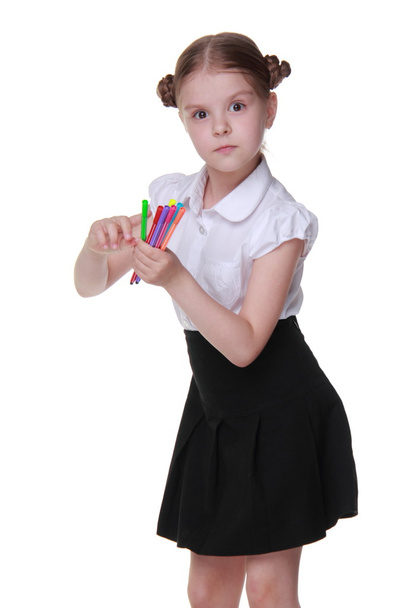 Studio portrait of schoolgirl with felt-tip pens - 写真・画像