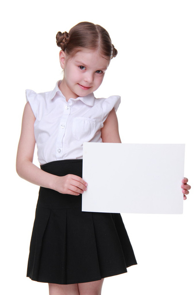 Happy schoolgirl with a sheet of paper - Zdjęcie, obraz